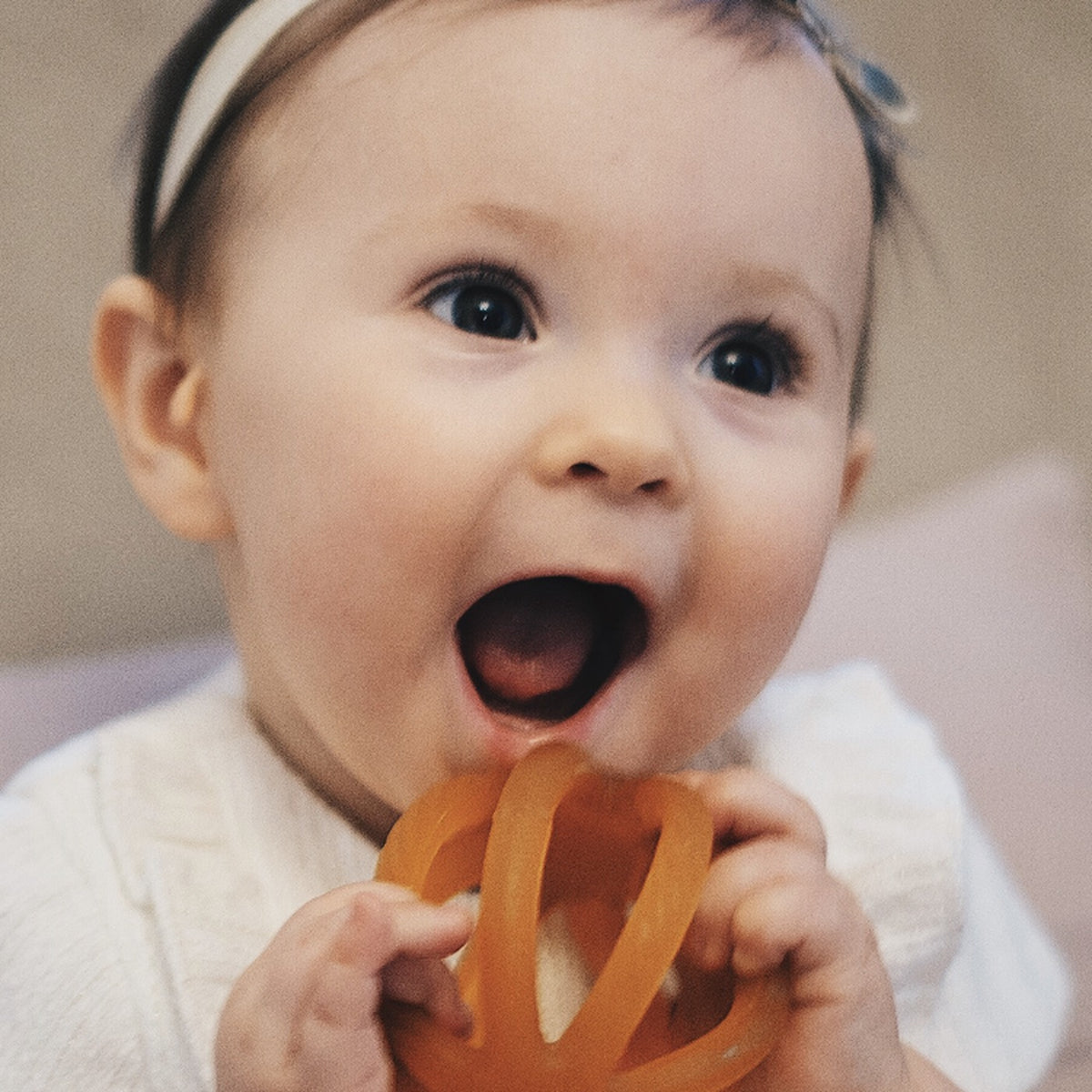 Happy baby with a Calmies teether